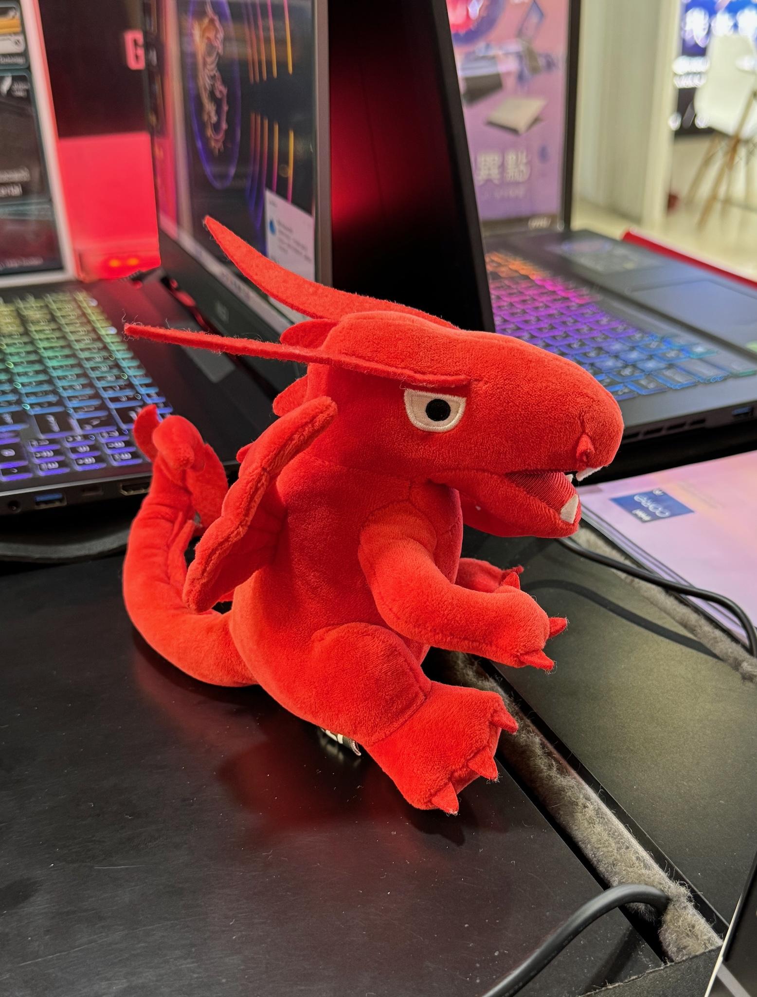 A laptop manufacturer's dragon mascot plush